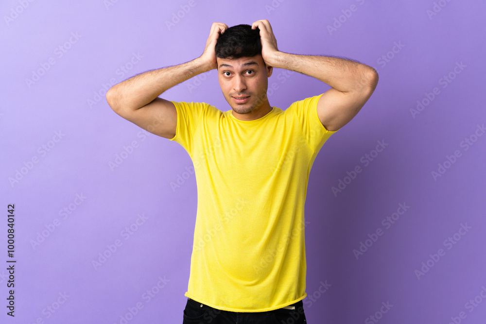 Young Colombian man isolated on purple background doing nervous gesture Young Colombian man isolated on purple background doing nervous gesture