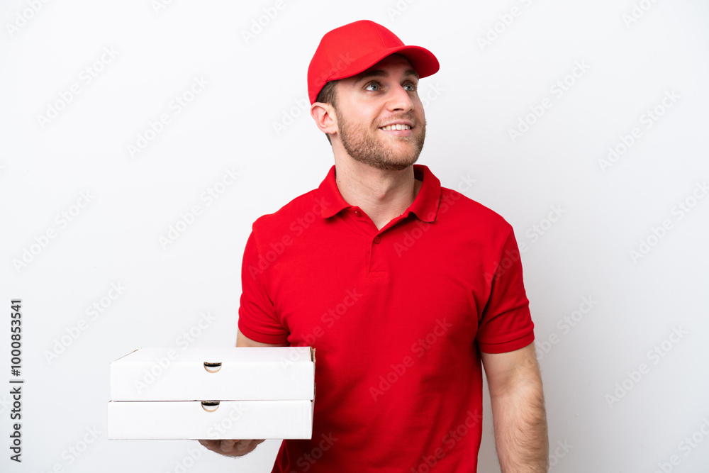Pizza delivery caucasian man with work uniform picking up pizza boxes isolated on white background thinking an idea while looking up Pizza delivery caucasian man with work uniform picking up pizza boxes isolated on white background thinking an idea while looking up