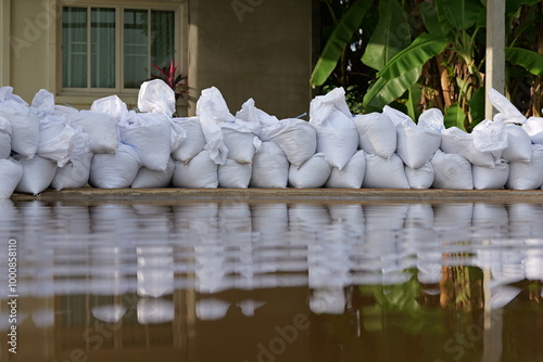 Sandbag for flood protection. A pile or wall of sandbags at the front entrance of a house, next to street, to keep flooding water out of the residence