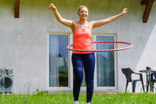 Young woman with hoola hoop outdoors photo