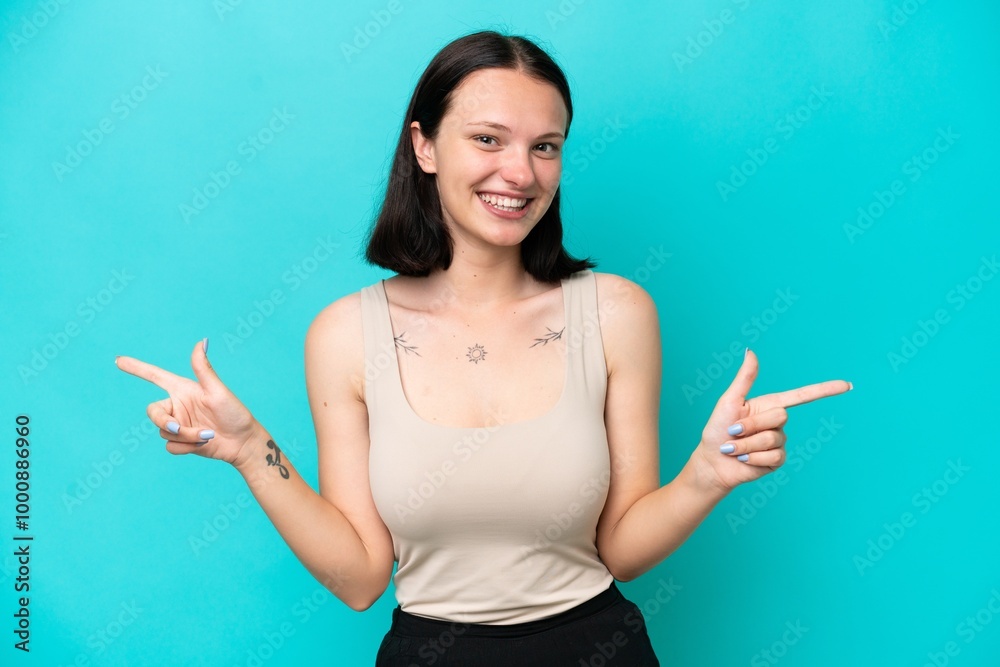 Young caucasian woman isolated on blue background pointing finger to the laterals and happy Young caucasian woman isolated on blue background pointing finger to the laterals and happy