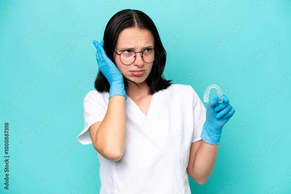 Young caucasian woman holding envisaging isolated on blue background frustrated and covering ears Young caucasian woman holding envisaging isolated on blue background frustrated and covering ears