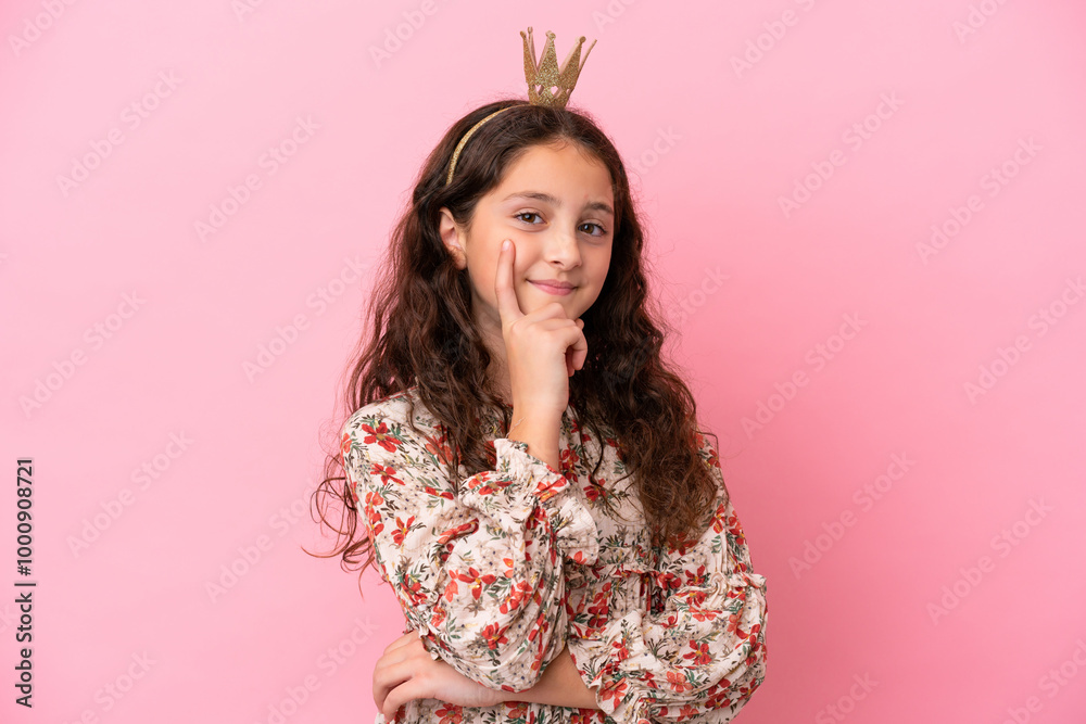 Little caucasian princess with crown isolated on pink background thinking an idea while looking up Little caucasian princess with crown isolated on pink background thinking an idea while looking up