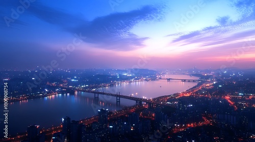 A panoramic view of a city at night with a river and bridges in the foreground.