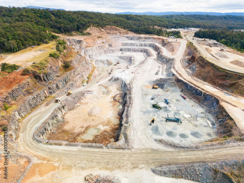 Aerial view over a quarry pit with machinery haulage roads