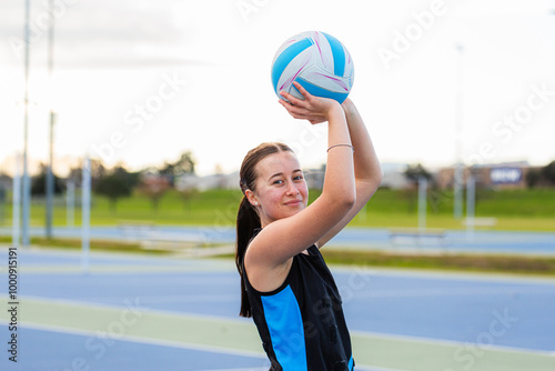 Young aboriginal sports player with ball training for netball game photo