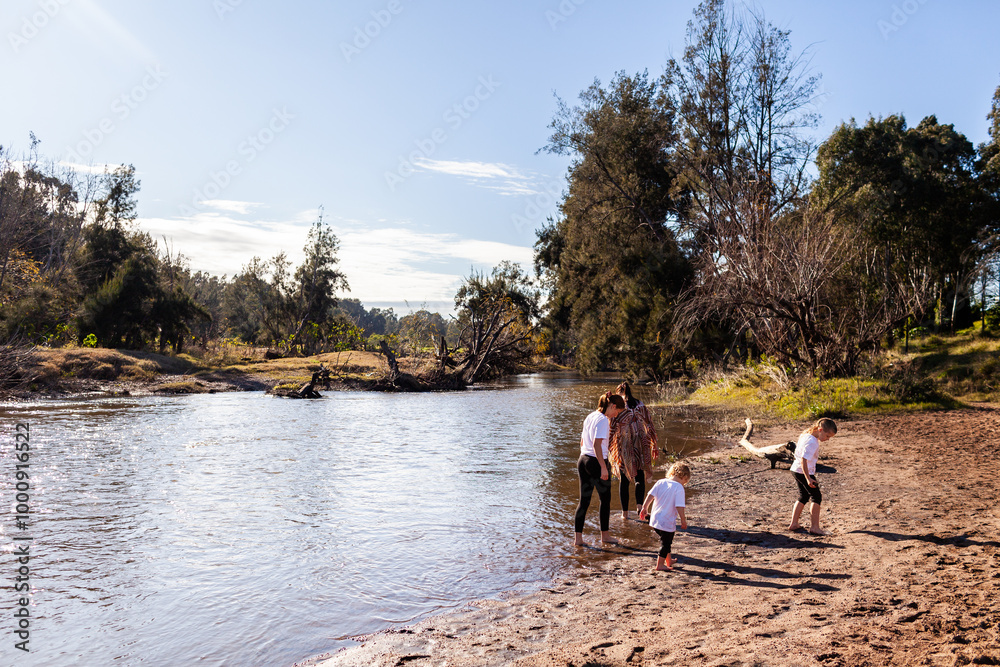 Aussie siblings playing down by river on sunny morning Aussie siblings playing down by river on sunny morning