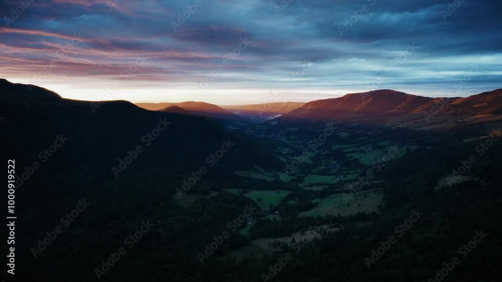 Magnificent landscape of ancient volcanoes at sunset with golden rays of light in the valley, 4K aerial view, Auvergne, France. Magnificent landscape of ancient volcanoes at sunset with golden rays of light in the valley, 4K aerial view, Auvergne, France.