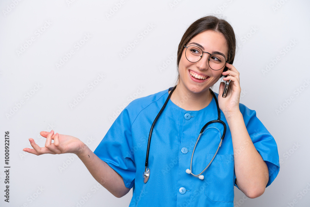 surgeon doctor woman holding tools isolated on white background keeping a conversation with the mobile phone with someone surgeon doctor woman holding tools isolated on white background keeping a conversation with the mobile phone with someone