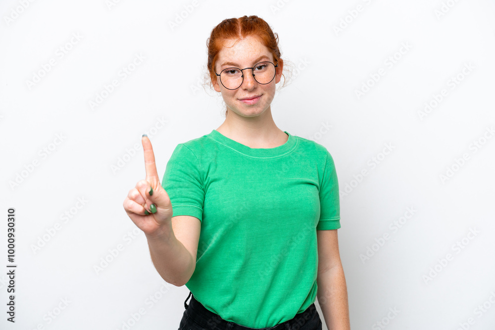 Young reddish woman isolated on white background showing and lifting a finger Young reddish woman isolated on white background showing and lifting a finger