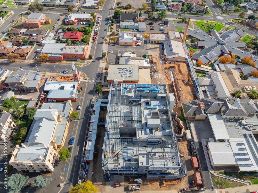 Aerial view of multi level construction site alongside existing city buildings Aerial view of multi level construction site alongside existing city buildings