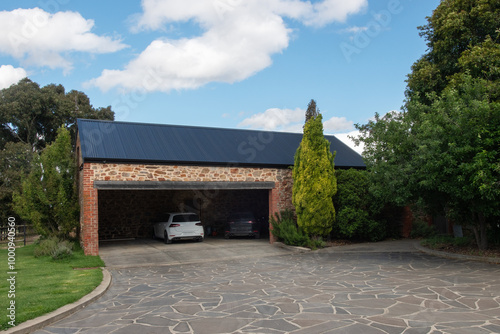 two cars parked in a stone garage