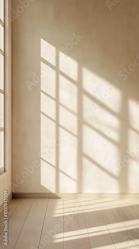 Bright sunbeams from a panoramic window casting shadows on a smooth beige wall. Simple, empty room with natural light patterns. Minimalistic layout template for product presentation