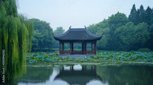 Chinese pavilion in park with trees and lotus plants, Hangzhou West Lake