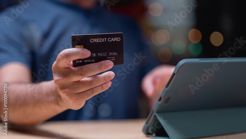 People shopping online using tablet concept. Person holds credit card while engaging in online shopping on tablet scene convenience of digital transactions in todays modern world