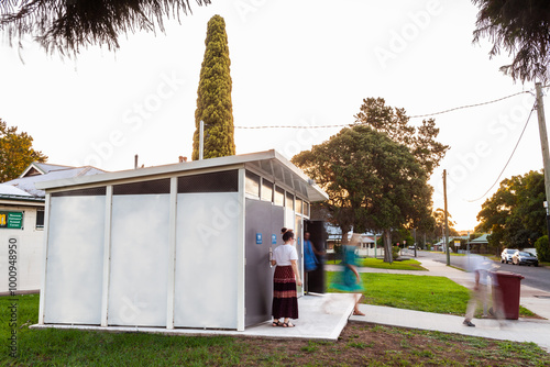 long exposure of public toilet block in park with blurred people