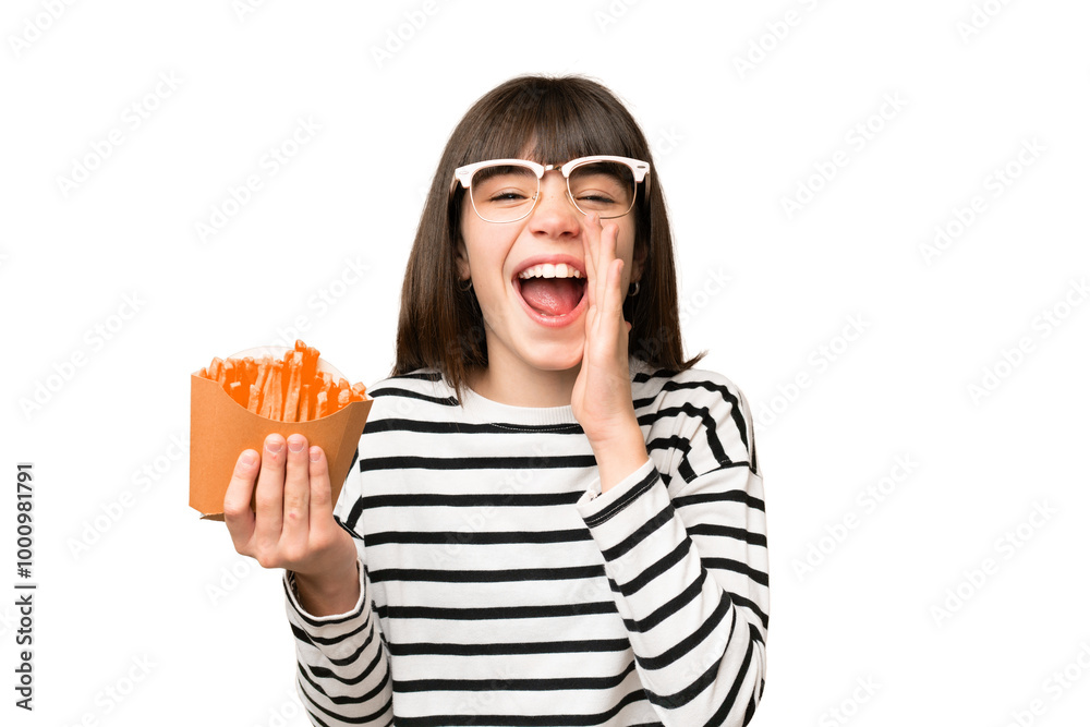 Little girl holding fried chips over isolated chroma key background shouting with mouth wide open Little girl holding fried chips over isolated chroma key background shouting with mouth wide open