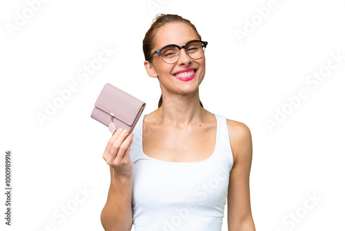 Young caucasian woman holding a wallet over isolated background smiling a lot