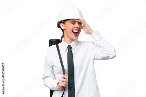 Young architect woman with helmet and holding blueprints over isolated background smiling a lot