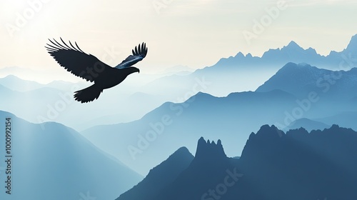 Silhouette of an eagle soaring above a mountain range with space for copy in the open sky.