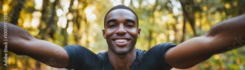 Smiling Young Man Taking a Selfie in a Forest During a Sunny Day