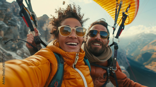 Biracial couple paragliding over scenic mountains, enjoying an adventurous vacation experience, breathtaking views, outdoor thrill, travel excursion, and adrenaline-filled adventure in nature.