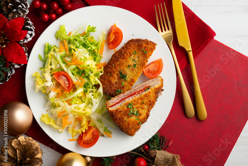 Asturian Cachopo. Breaded beef fillet stuffed with cheese and pepper. Top view table with Christmas decoration. photo