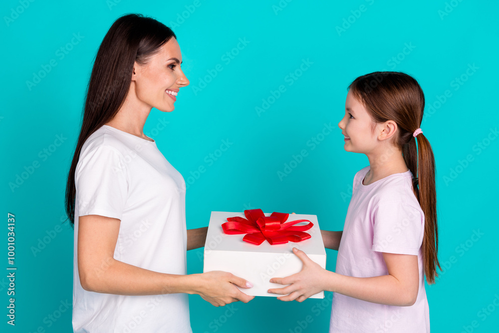 Photo of charming cute little girl greetings mom dressed white stylish clothes isolated on cyan color background Photo of charming cute little girl greetings mom dressed white stylish clothes isolated on cyan color background