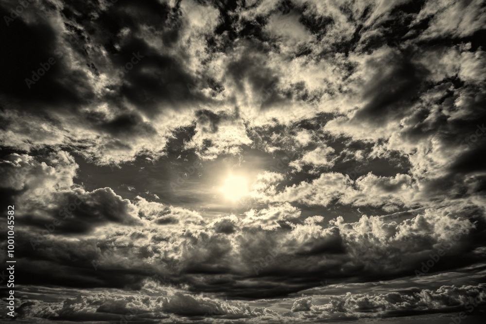 dramatic cloudy sky with sun peeking through dramatic cloudy sky with sun peeking through