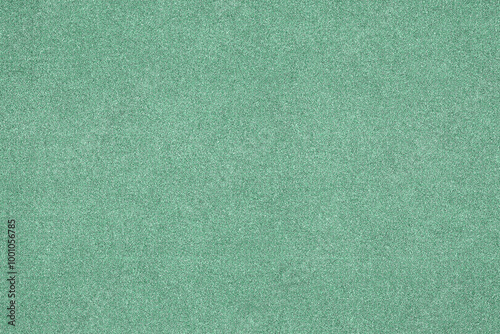 A plain green background with a fine grain texture, ideal for design or wallpaper