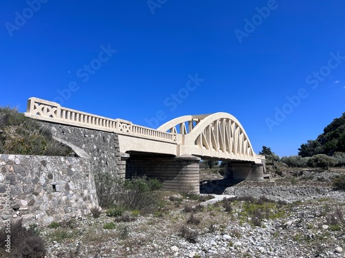 Medieval stone bridge Italian Arch Bridge Rhodes. With dryly river. photo