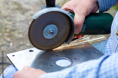 Cutting metal with a grinder. Processing and grinding of metal with sparks photo