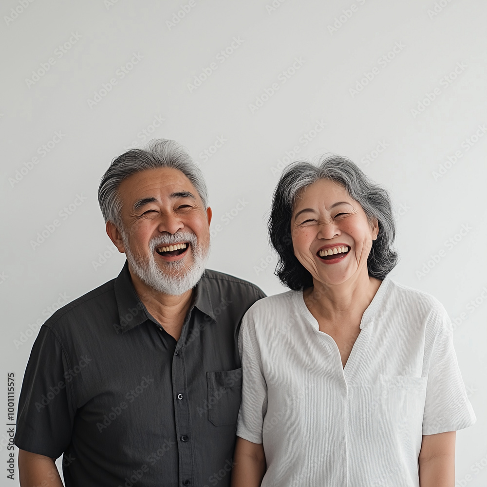 An old Asian couple dressed in casual everyday wear, caught in a moment of shared laughter happy lovebird on the solid background
An old Asian couple dressed in casual everyday wear, caught in a moment of shared laughter happy lovebird on the solid background