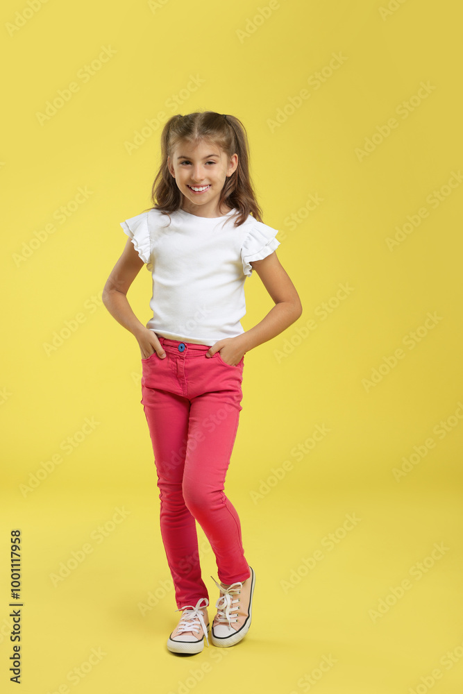 Full length portrait of cute girl on yellow background Full length portrait of cute girl on yellow background