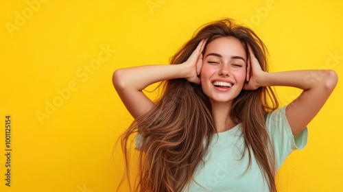 Joyful Woman with Long Hair Against Yellow Background