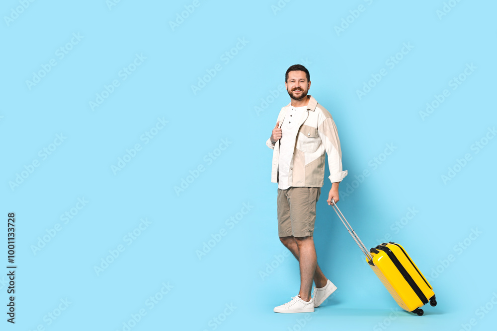 Happy man with suitcase on light blue background, space for text Happy man with suitcase on light blue background, space for text
