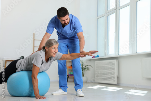 Physiotherapist working with senior patient in rehabilitation center