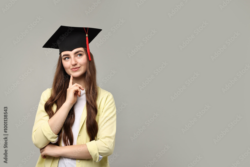 Thoughtful student after graduation on grey background. Space for text Thoughtful student after graduation on grey background. Space for text