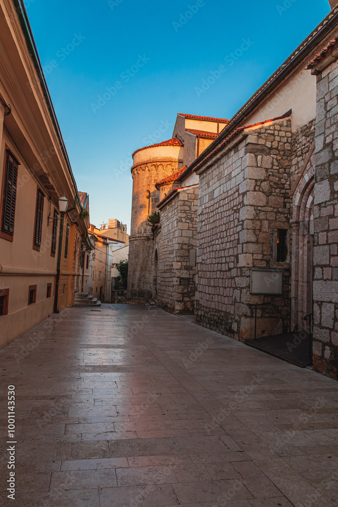 Krk Croatia 28.06.24A quiet street at dawn near an old church Krk Croatia 28.06.24A quiet street at dawn near an old church