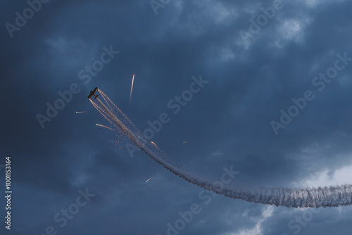 Stunt Plane shooting fireworks in the clouds