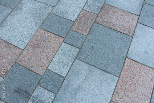 Texture of square paving tile. Pattern of sidewalk tiles in the street. Concrete pavers close up background.