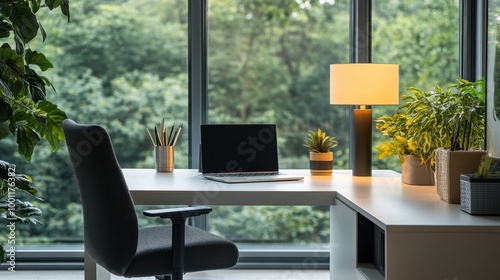 A cozy and contemporary home office space featuring a sleek white desk, black chair with cushion, table lamp, and a view of greenery outside the window.