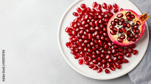 Fresh Pomegranate Seeds on White Plate: Healthy and Nutritious Superfood