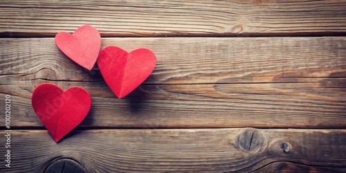 Romantic paper hearts kissing on textured wood background for love and Valentine's Day celebration concept