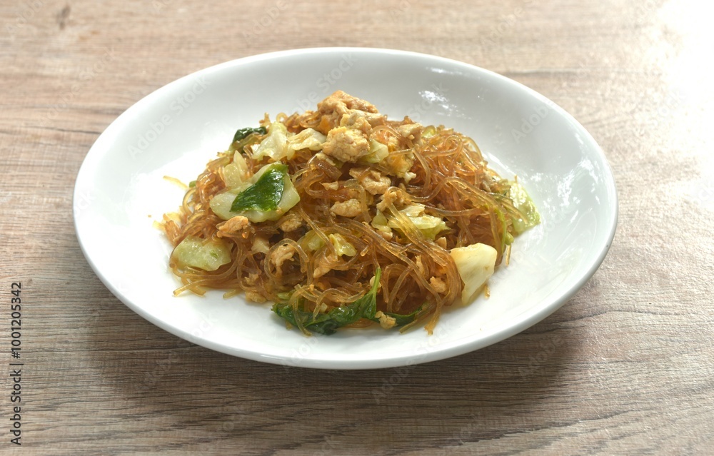 fried glass noodles with egg and cabbage in black sweet soy sauce on plate fried glass noodles with egg and cabbage in black sweet soy sauce on plate