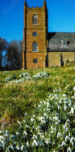 anglican parish church of england with snowdrops in front