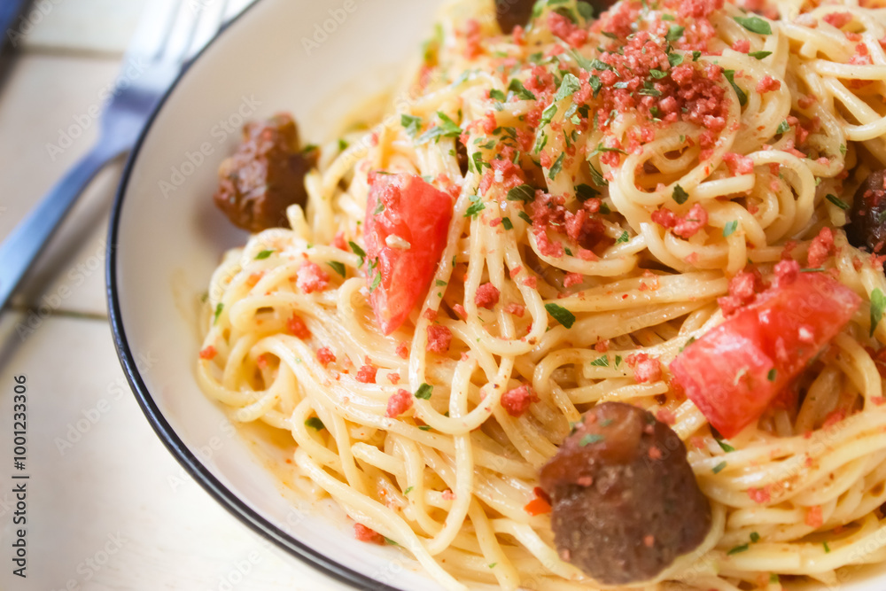 close-up of spaghetti dish with toppings and meat on table close-up of spaghetti dish with toppings and meat on table