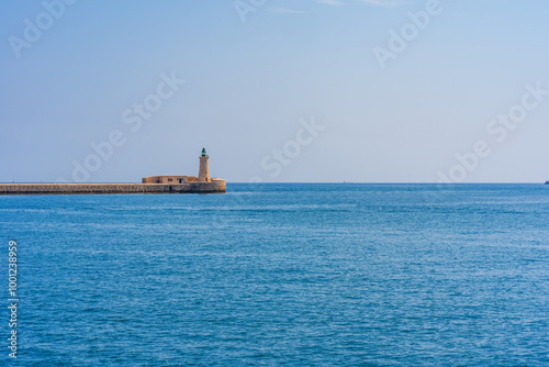 Lighthouse on the St. Elmo breakwater in Valletta Grand Harbour, Malta. photo