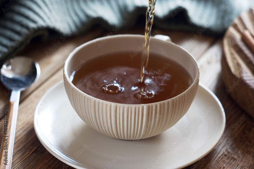 Black tea is poured into a mug Black tea is poured into a mug
