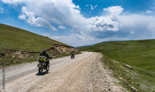 Motor cycle bike riders hiking in the mountans of Kyrgystan photo